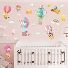 Detail of colorful hot air balloon wall decals with elephant and owl in a kids bedroom