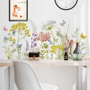 Close-up of vibrant wildflower wall stickers with daisies and butterflies in a home office