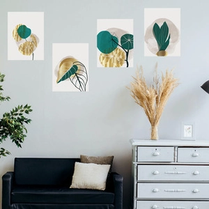 Detail of four creative tropical leaf switch stickers with gold and green aesthetic decor