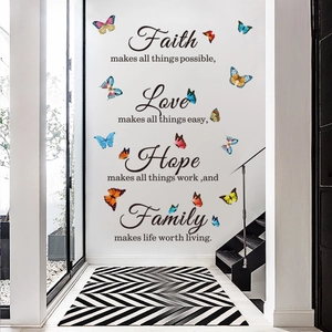 Détail du sticker mural Faith Hope Love avec papillons colorés sur mur de couloir blanc