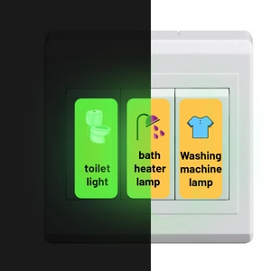 Luminous light switch stickers showing toilet and bath heater icons in the dark