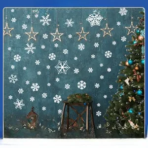 Detail view of white snowflake and glowing star wall decals for Christmas home decoration