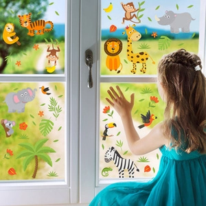 Detail showing tropical animal window stickers with lions and giraffes in a nursery setting