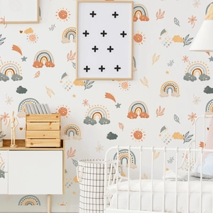 Detail view of boho rainbow wall decals with sun and stars in a cozy nursery setting