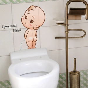Detail of funny cartoon baby toilet sticker with Flush it text on white tiled wall