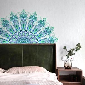 Detail of semi-circular mandala wall sticker in teal and blue on bedroom headboard wall
