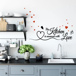 Détail du sticker mural 'This Kitchen is seasoned with Love' avec des cœurs rouges