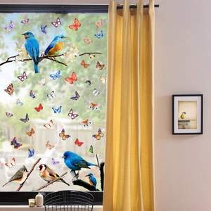 Detailed view of colorful static cling birds and butterflies stickers on a glass window