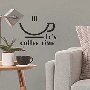 Close-up of It's coffee TIME wall decal on a light grey wall with a small plant