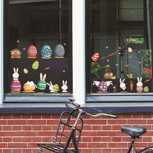 Detailed view of Easter window stickers with cartoon bunnies and colorful eggs on glass
