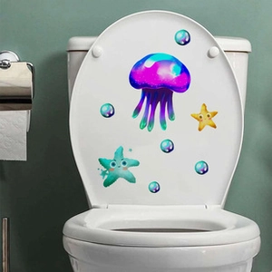 Detail view of colorful jellyfish and starfish decals on a white toilet lid cover