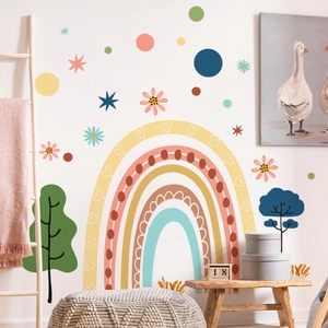 Close-up of bohemian nursery wall decals featuring a large rainbow and nature elements