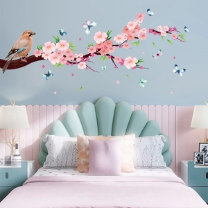 Floral wall sticker featuring peach blossoms, a brown bird, and blue butterflies
