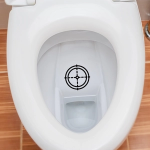 Waterproof target sticker for potty training with crosshair design on white toilet