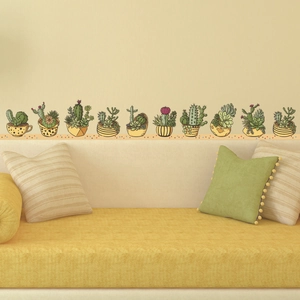 Hand-painted cactus and succulent wall stickers above a yellow sofa for home decor