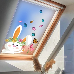 Close-up of bunny and butterfly static window stickers on a skylight glass panel
