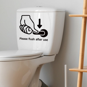 Self-adhesive black sticker with Please flush after use text on white toilet tank