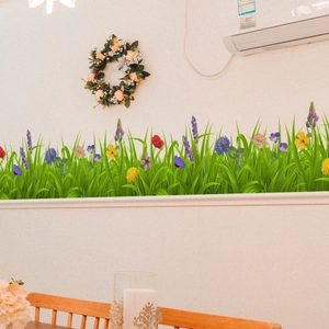Detailed view of green grass and colorful wildflower wall stickers for baseboard decor