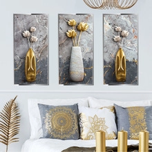 Three-piece wall art set featuring embossed gold and white floral motifs in a bedroom setting
