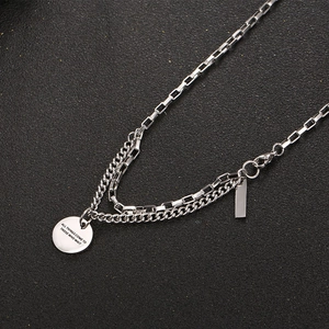 Double-layered titanium steel necklace with a polished round pendant and engraved bar