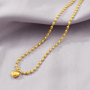Elegant gold titanium steel heart necklace featuring small oval beads and a polished finish