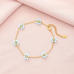 Elegant gold-plated stainless steel necklace with blue daisy flower charms and pearl beads