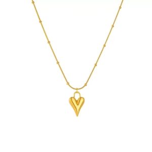 Close-up of polished 3D gold heart pendant with beaded snake chain necklace details