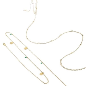 Gold body chain with emerald green beads and round metal sequins on white background