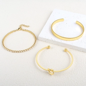 Gold stainless steel knot cuff, wide bangle, and zircon tennis bracelet set for women