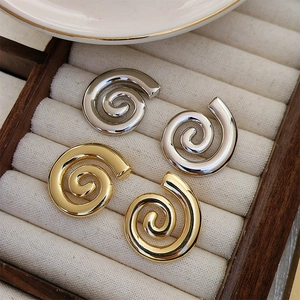 Chic 18K gold and silver plated geometric spiral earrings displayed in a jewelry box
