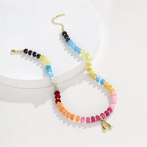 Collana di perle colorate con ciondolo a lettera A dorata per un vivace look estivo