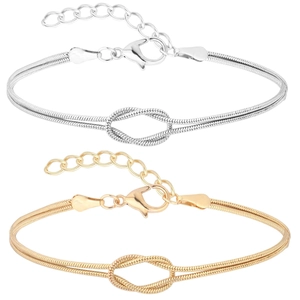 Macro detail of gold and silver knot snake chain bracelets with lobster clasp and extender