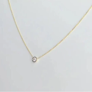 Elegant minimalist gold chain necklace with a bezel-set round diamond pendant for women