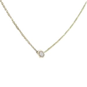 Minimalist gold necklace with a round bezel-set zircon pendant on a thin metal chain