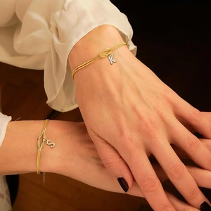 Golden snake chain bracelets with sparkling zircon letter pendants and knot charms