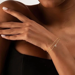 Double-layer gold stainless steel bracelet with crystal letter A pendant on a model