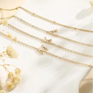 Layered gold stainless steel beaded chain necklace with sparkling zircon A K M pendants