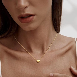 Layered 14k gold plated heart pendant necklace with letter A engraving on female model