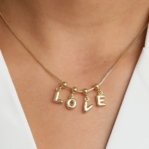 Minimalist 18k gold plated bubble letter necklace featuring a polished LOVE pendant