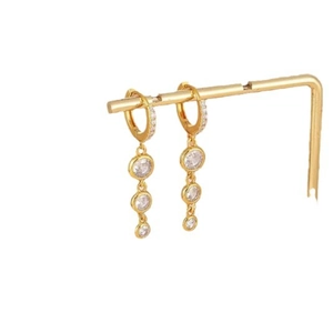 Luxury gold-plated brass drop earrings with shimmering zircon stones on a gold stand