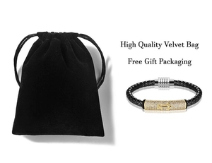 Close-up of black braided leather bracelet with anchor gold charm and gift velvet bag