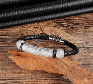 Close-up of woven leather bracelet with zircon anchor charm and magnetic clasp