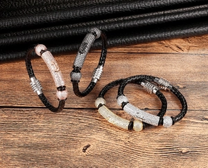 Close-up of braided leather bracelets with CZ pave tube and magnetic clasps in four colors