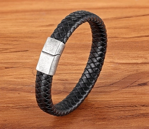 Close-up of double-layer black braided leather bracelet with brushed metal magnetic clasp