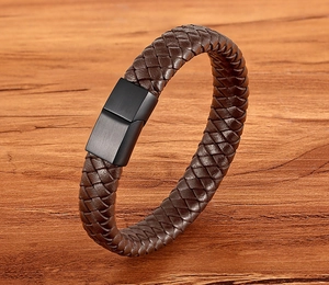 Detailed macro view of a brown braided leather bracelet with black matte magnetic clasp