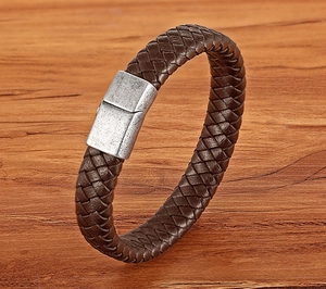 Detail of double-layer dark brown braided leather bracelet with vintage silver magnetic clasp