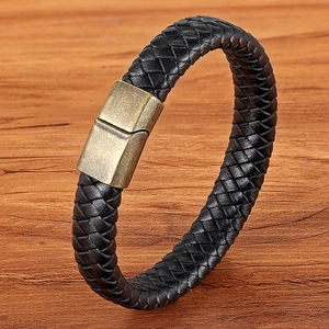 Men's double-layered black woven leather bracelet with bronze magnetic clasp on wood