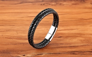Detailed close-up of double-layer black braided leather bracelet with silver magnetic clasp