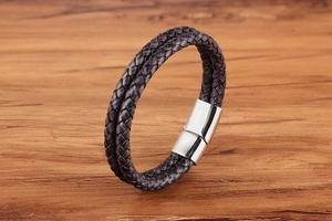 Detail of double-strand braided brown leather bracelet with polished silver magnetic clasp
