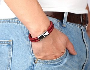 Detail view of red braided leather bracelet with a polished silver magnetic clasp